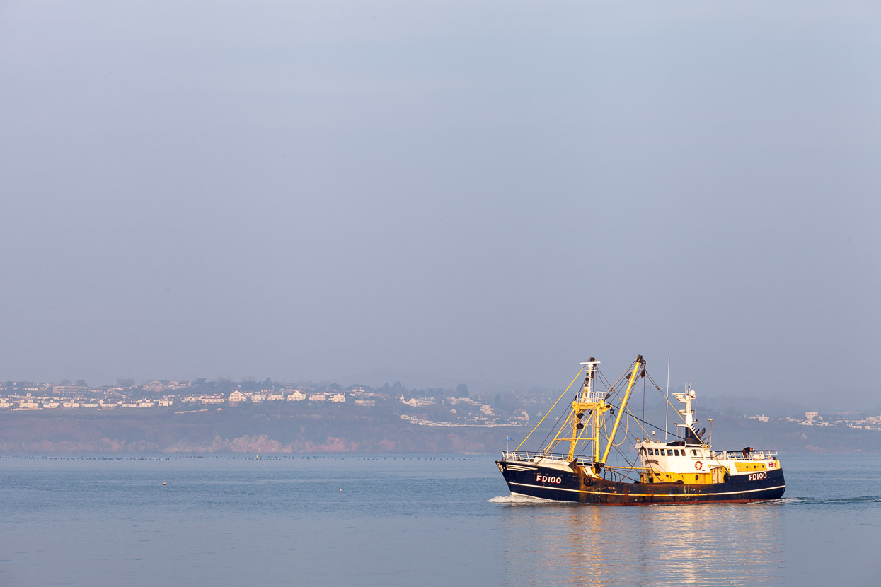 Fishing boat heads back to Brixham Harbour