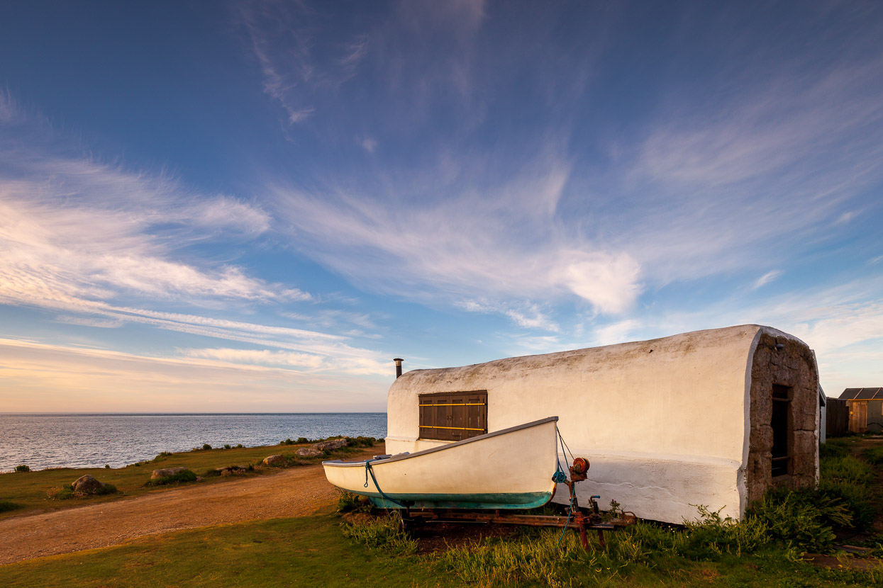 A small shed overlooks the sea at Portland Bill, Dorset by David Gibbeson