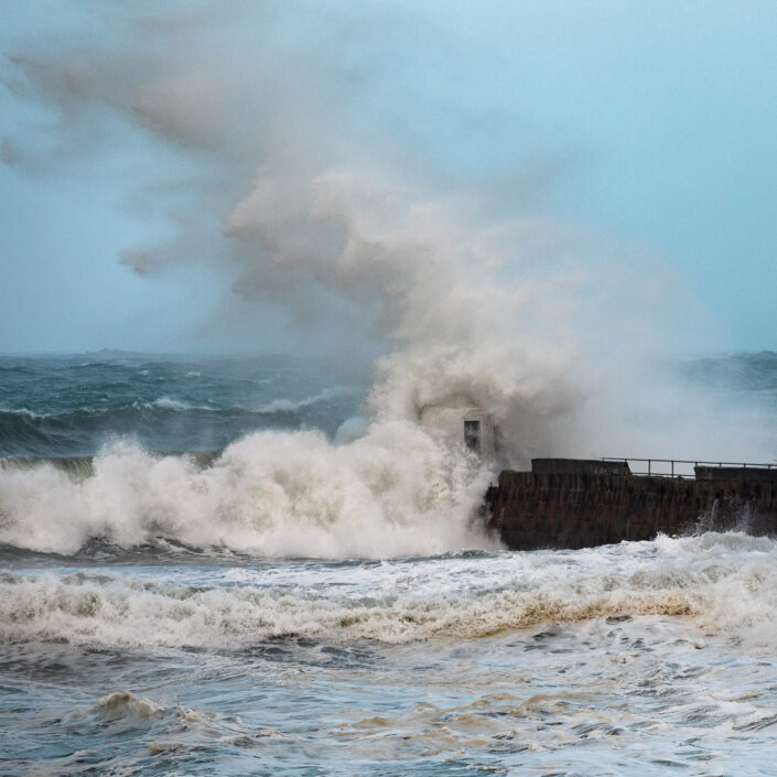 A giant wave towers above the breakwater at Portreath, Cornwall during storm Ciara - David Gibbeson